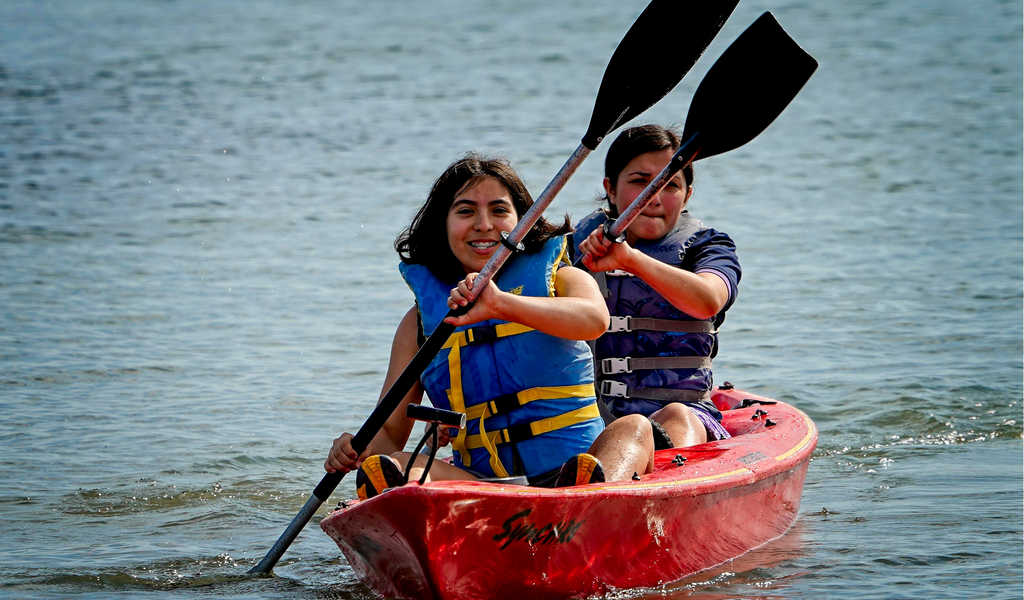 Scouts BSA girls paddling a kayak