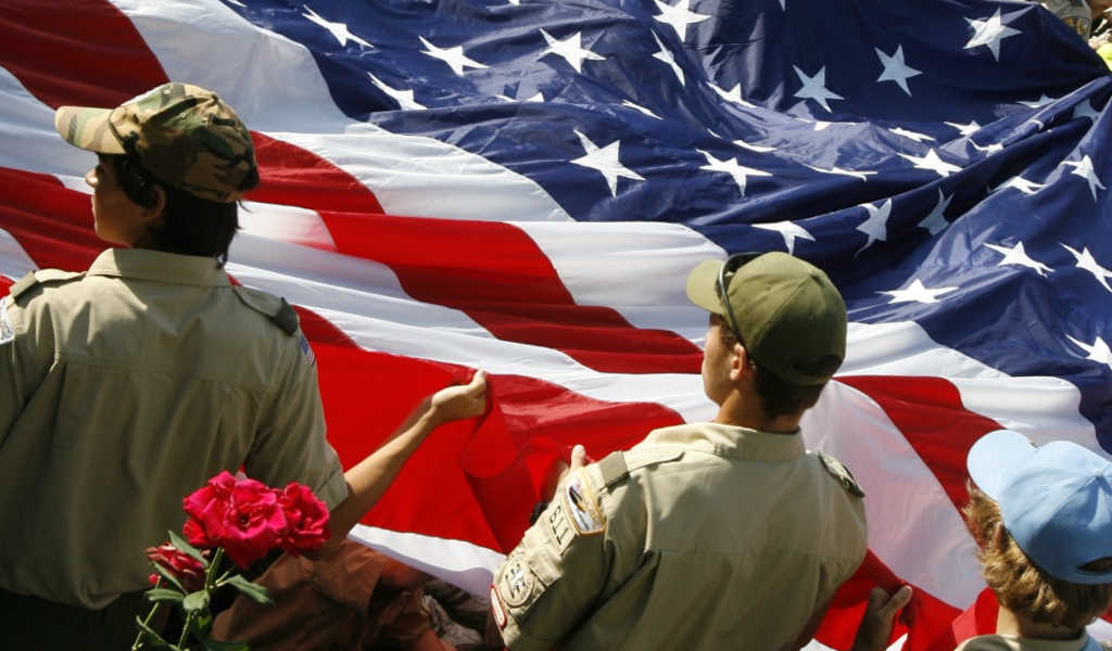 Scouts BSA boys handling a large flag