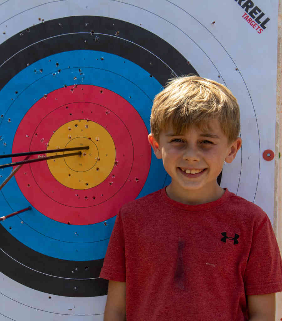 Cub Scout with archery target