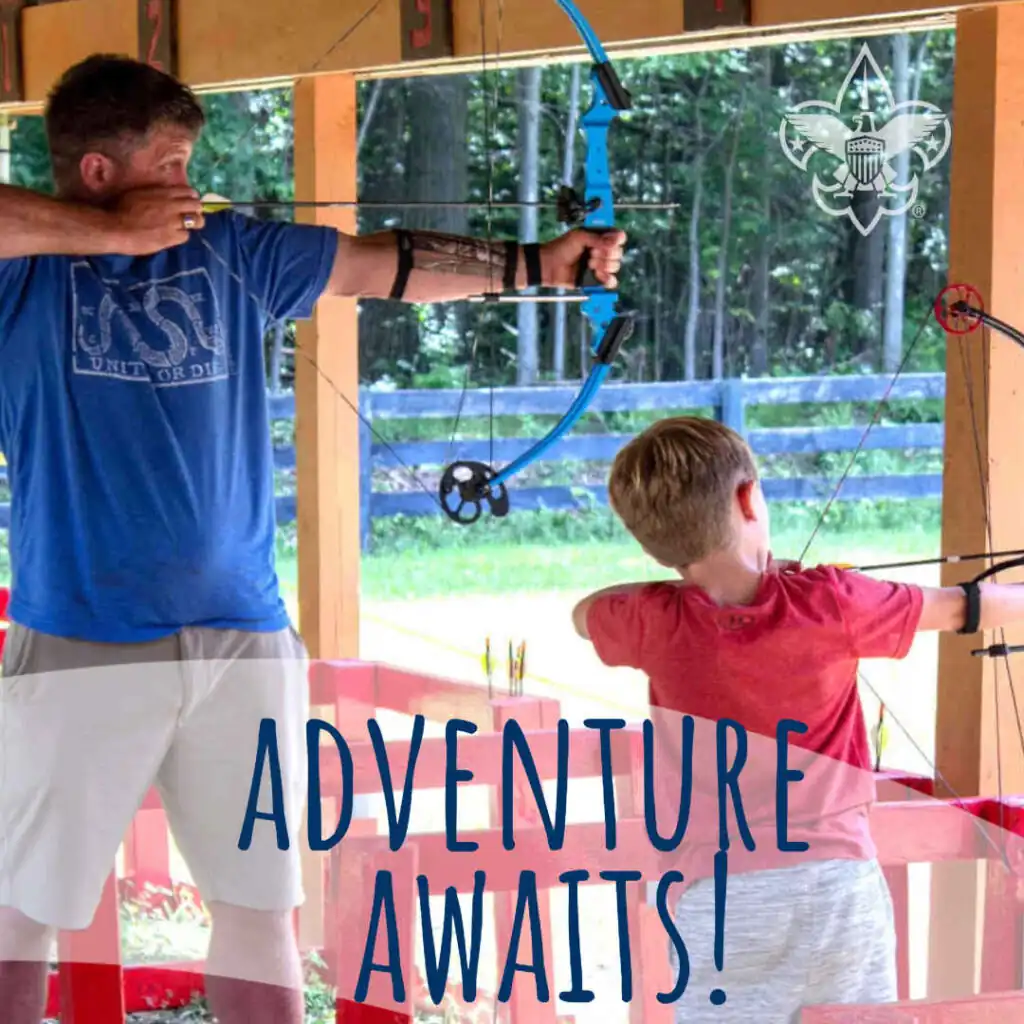 Cub Scout and father at archery range