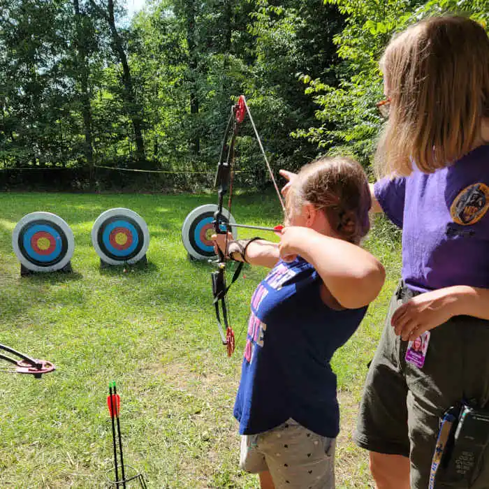 Cub Scout girl at archery range