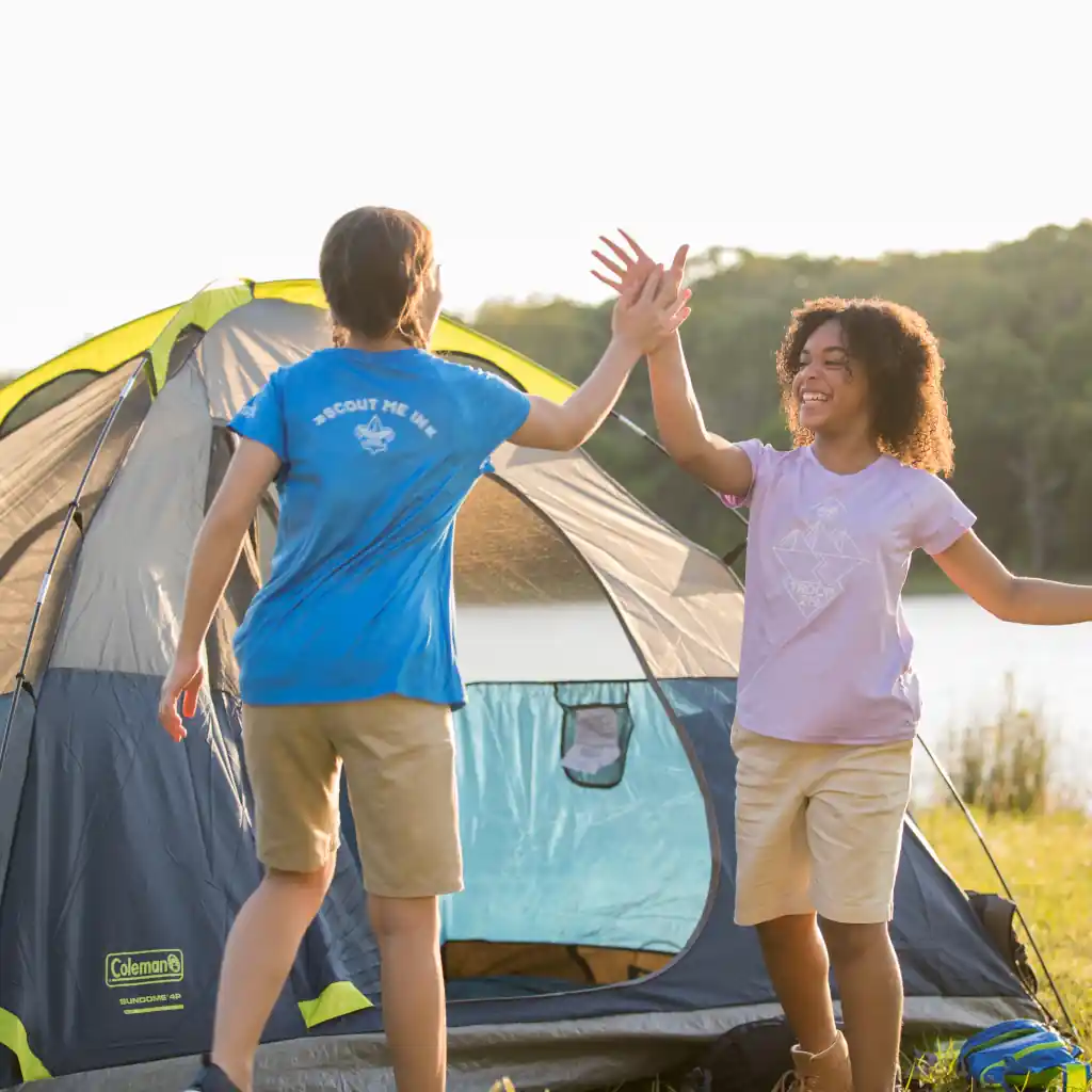 Two Scouts BSA girls setting up a tent