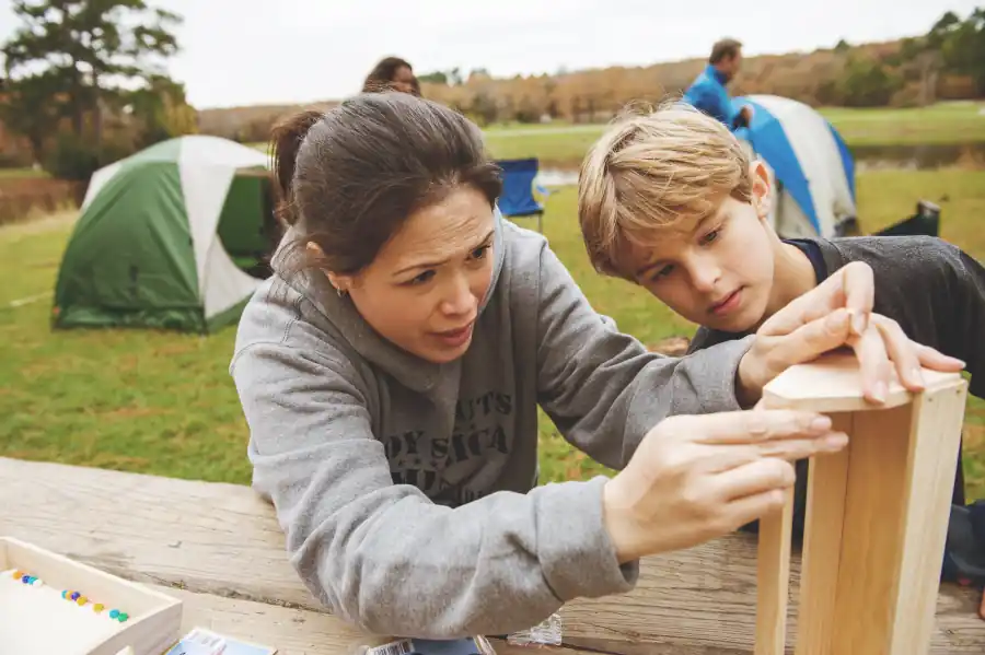 Parent helping a Scout with a building project